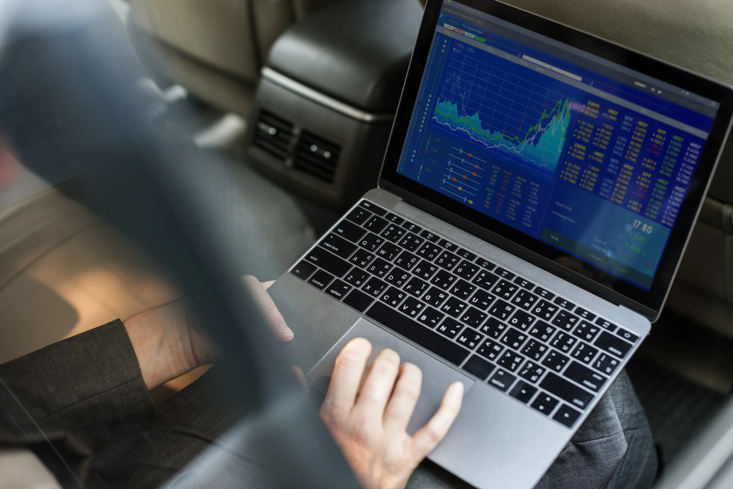 Professional trader analyzing multiple currency positions on computer screen displaying forex market charts