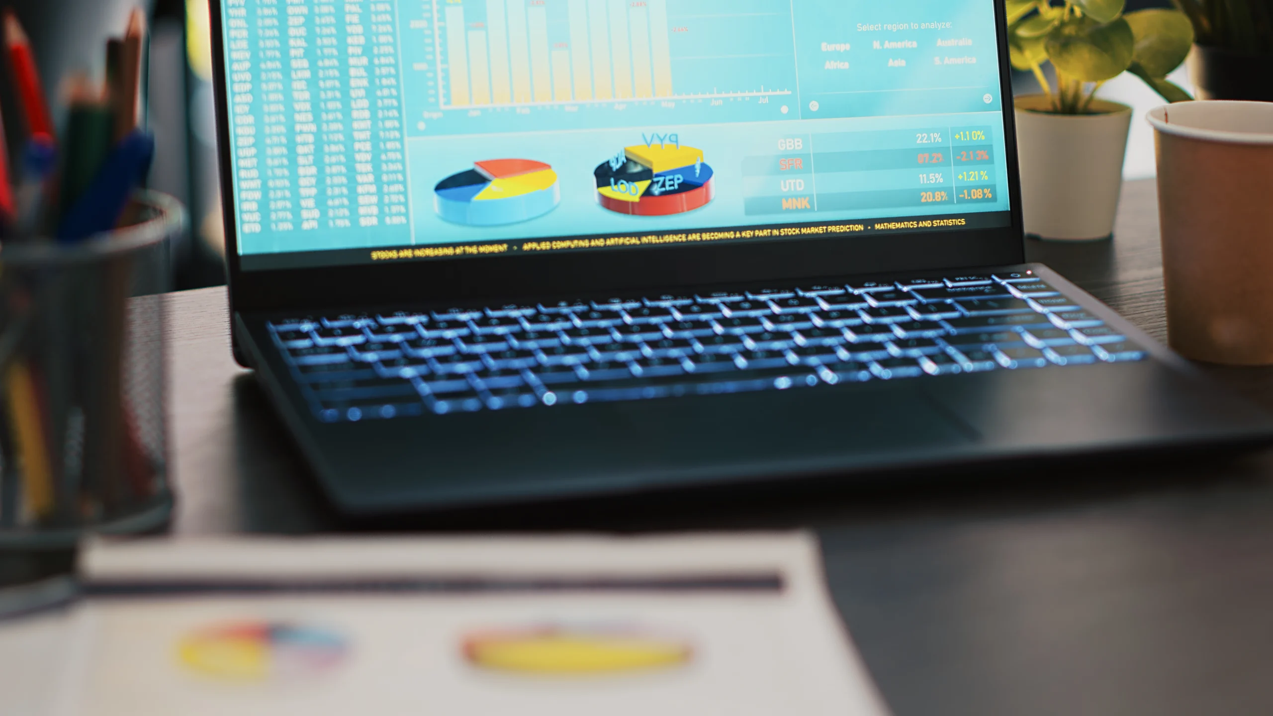 financial report desk laptop showing marketing statistics office scaled