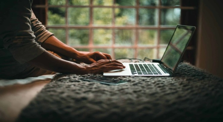 A Man Working Online on a Laptop
