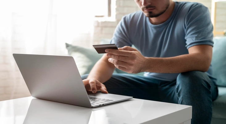 Man Using His Credit Card and Paying Online