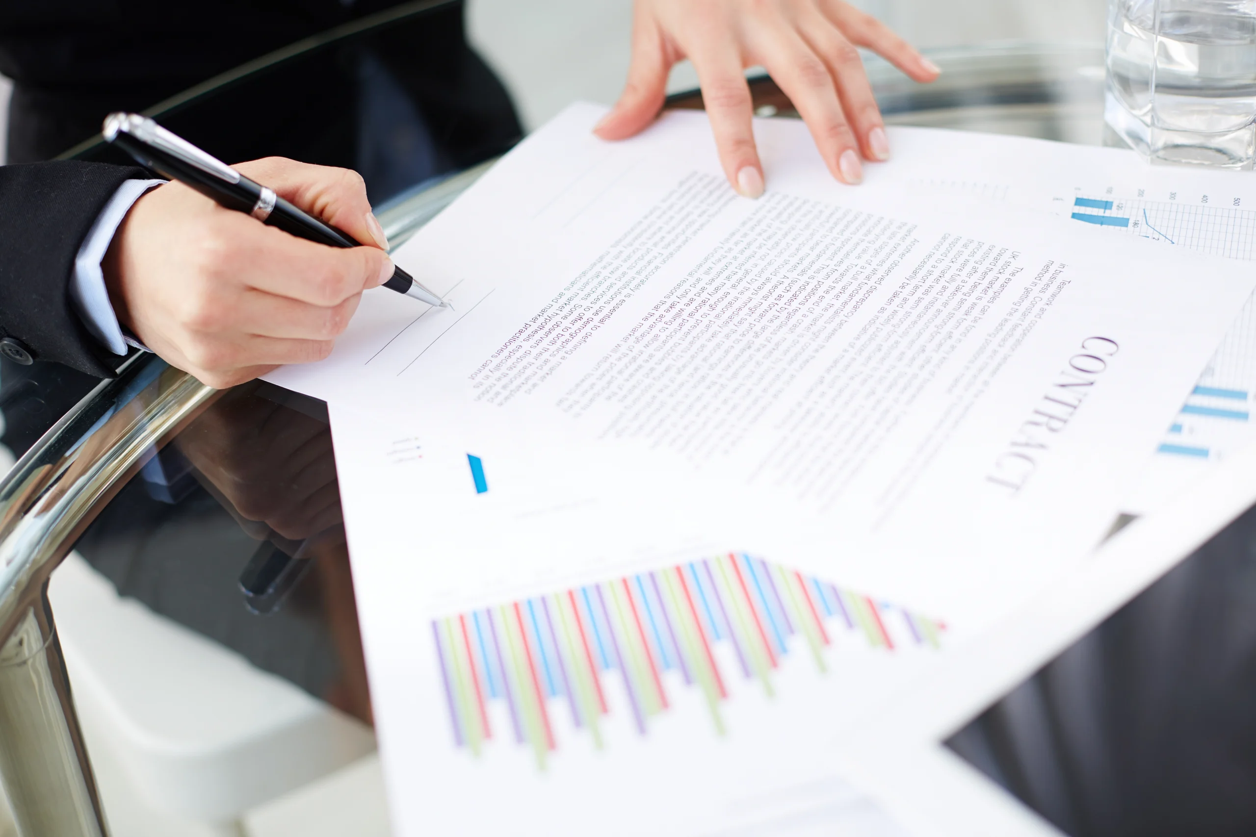 Business professional explaining contract for difference basics with documents and calculator on modern office desk